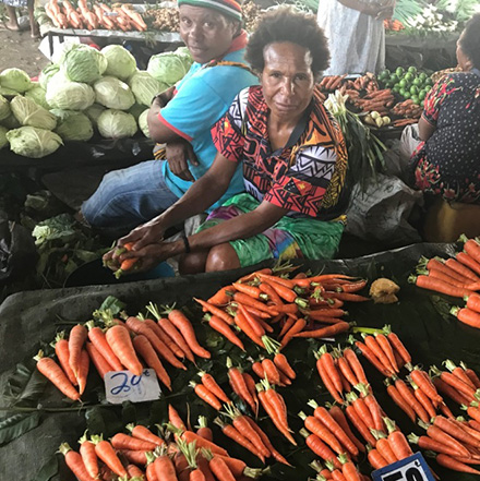 woman selling vegetables at market