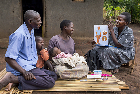 An African family listens to a family planning specialist.
