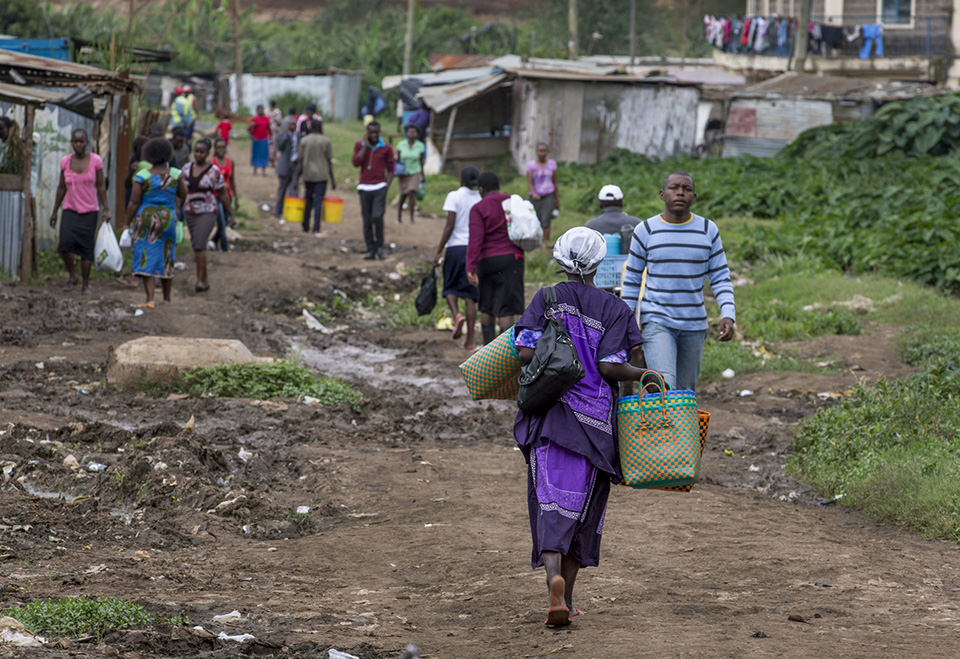 Nairobi village with a woman in purple walking.