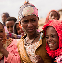 Ethiopian women in reds and pinks.