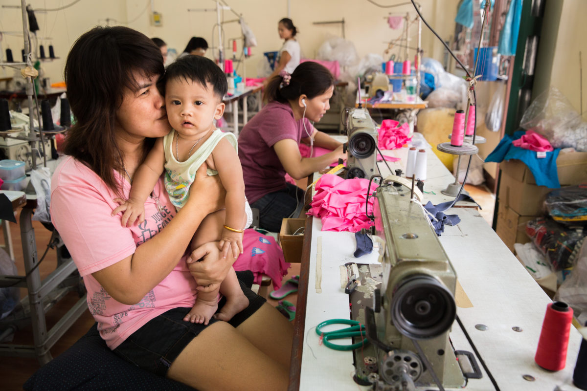 mother working with baby in arms