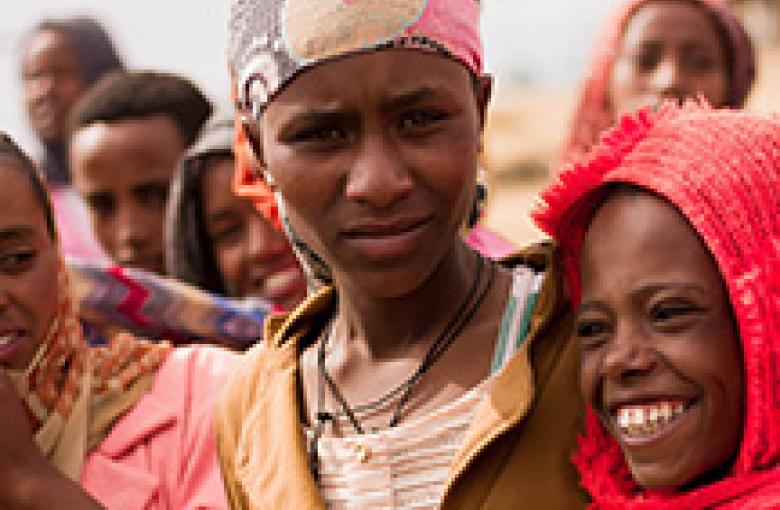 Ethiopian women in reds and pinks.